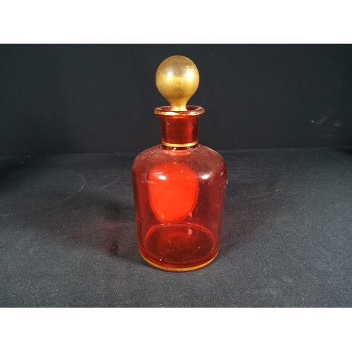 157 - Antique Cranberry glass bottle and stopper with porcelain plaque decoration by Whitefriars, 15cms in... 