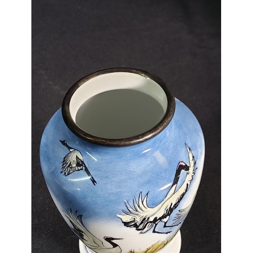 257 - Boxed enamelled Moorcroft vase decorated with  storks, 8cms in height