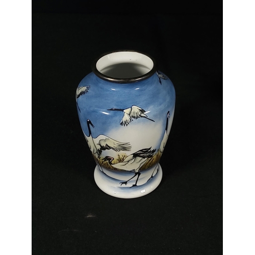 257 - Boxed enamelled Moorcroft vase decorated with  storks, 8cms in height