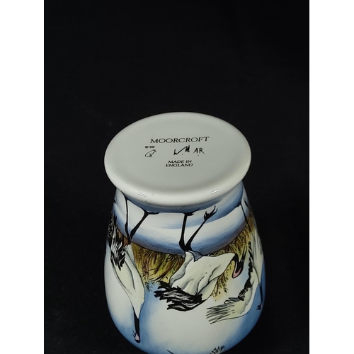 257 - Boxed enamelled Moorcroft vase decorated with  storks, 8cms in height