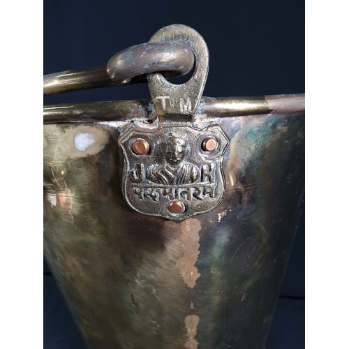 337 - Large antique brass bucket with markings, 32cms in height and 34cms in diameter