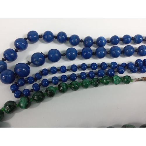 689 - 2 strings of stone beads