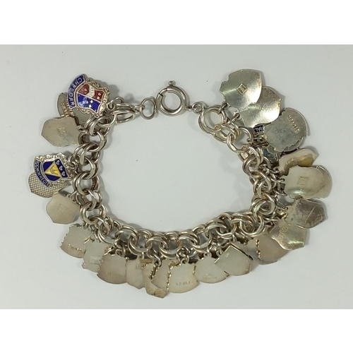 696 - Silver enamelled charmed bracelet, 59.3g gross