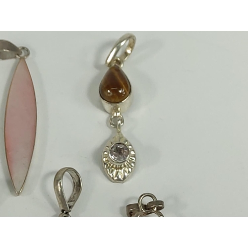 701 - Selection of various silver pendants