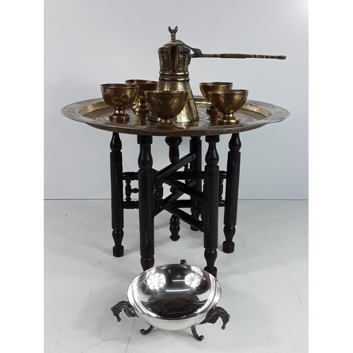 566 - Small brass topped tray table and Eastern drinks set with a sea horse pin dish