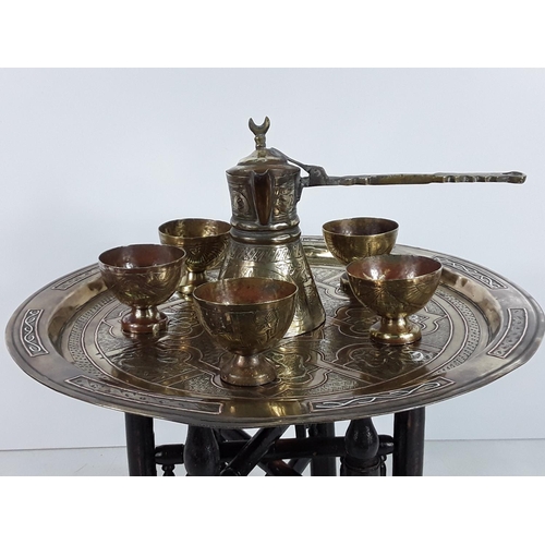 566 - Small brass topped tray table and Eastern drinks set with a sea horse pin dish