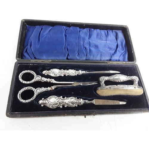 668 - Cased silver 4 piece manicure set and a fork