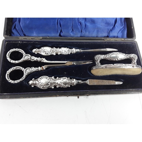 668 - Cased silver 4 piece manicure set and a fork