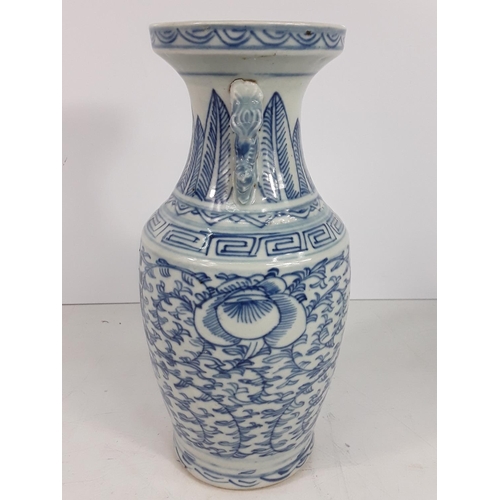 722 - Vintage oriental blue and white vase, 24cms in height