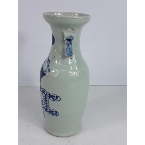 723 - Vintage oriental blue and white vase, 23cms in height