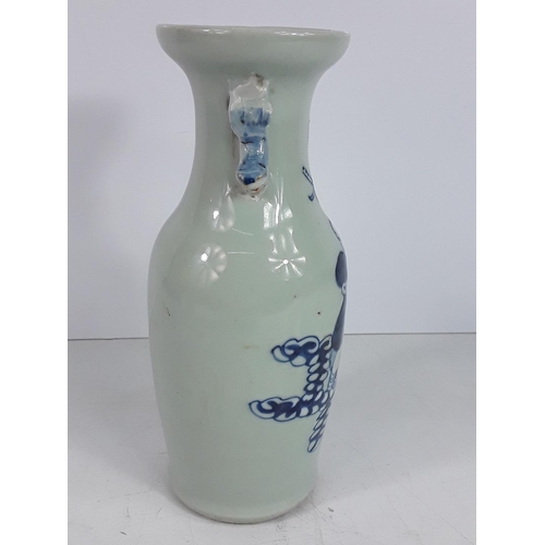 723 - Vintage oriental blue and white vase, 23cms in height