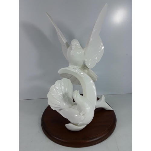 740 - Large Doulton Images of nature Doves on wooden base, 40cms in height without the plinth