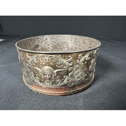 119 - Silver bottle coaster decorated with cherubs - gross 134g - 10.5cm dia