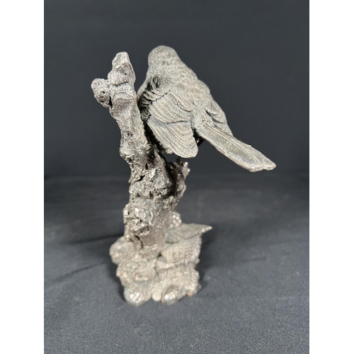 85 - Resin bird on a branch with silver overlay, 16cm tall