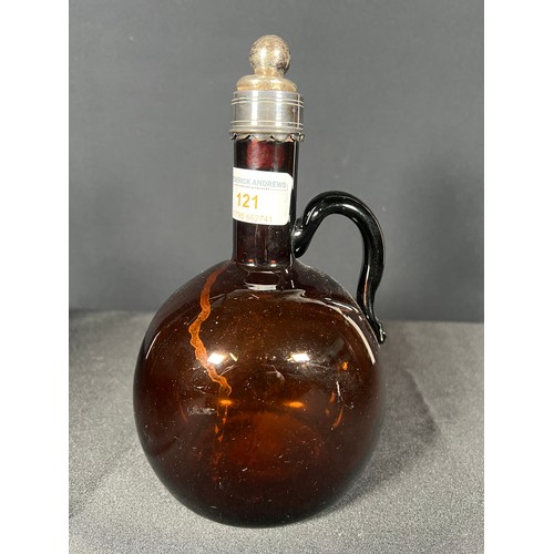 121 - Brown glass bottle with metal rim, 21cm tall