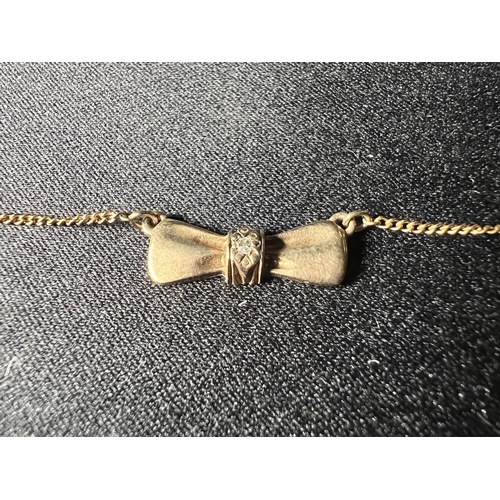500 - 9ct gold diamond set bow necklace, 2.8g