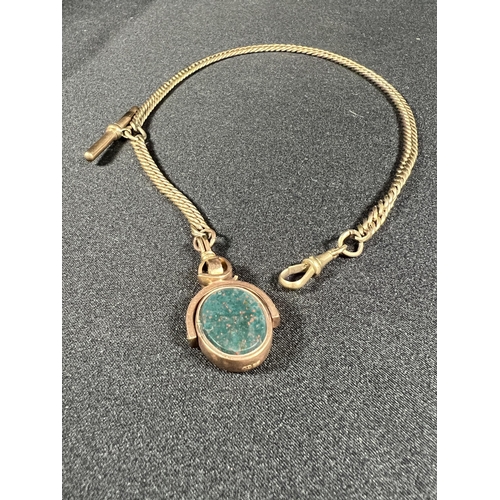 530 - 10ct gold stone set spinning fob on 9ct gold tested albert chain with T bar, 31g gross, chain weight... 