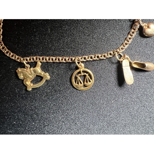 550 - 14ct gold charm bracelet with charms - 4.5g, 19cm