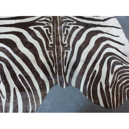 97 - Large cow hide rug with zebra print, approx 175 x 170cms