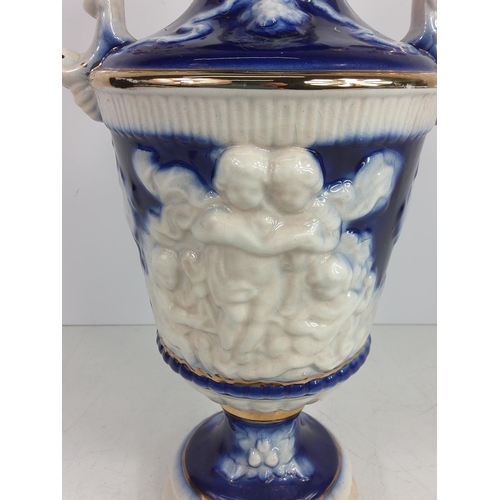 1 - Porcelain urn decorated with cherubs, 28cms in height