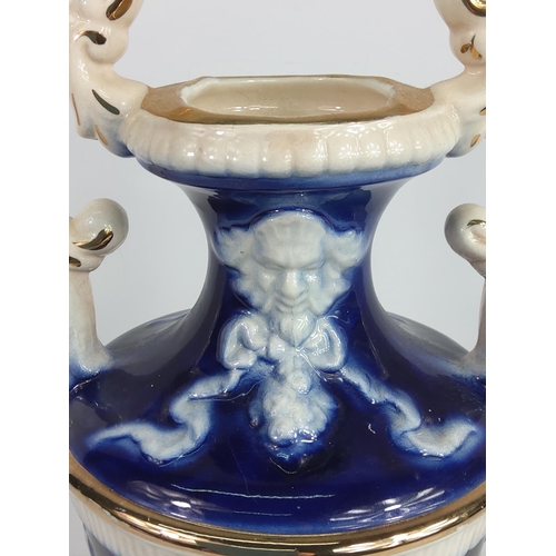 1 - Porcelain urn decorated with cherubs, 28cms in height