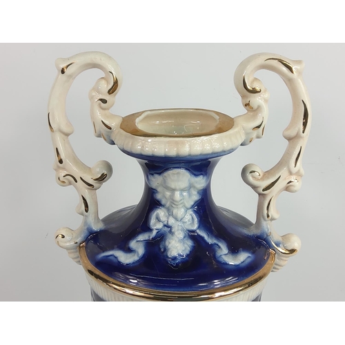 1 - Porcelain urn decorated with cherubs, 28cms in height