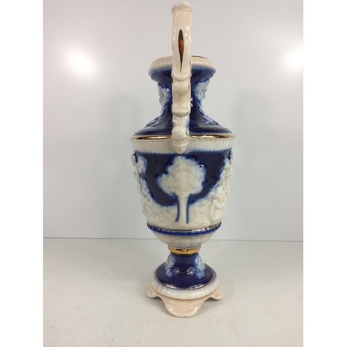 1 - Porcelain urn decorated with cherubs, 28cms in height