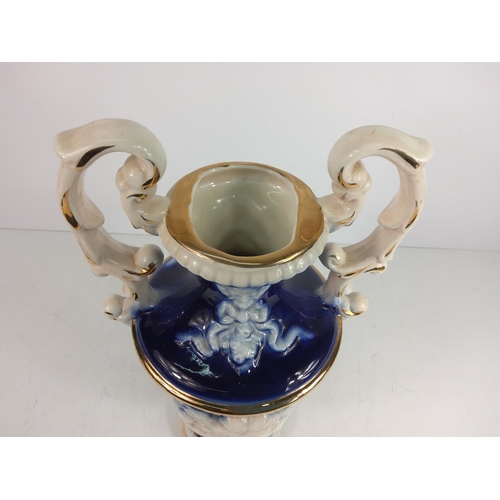 1 - Porcelain urn decorated with cherubs, 28cms in height