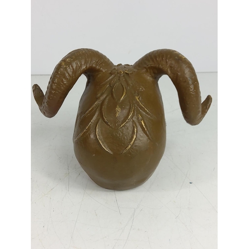 142 - Cast metal skull with horns, 12cms in height