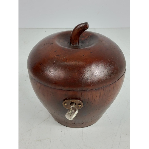 145 - Fruit wood tea caddy with key, 12cms in height, 11.5cms in diameter