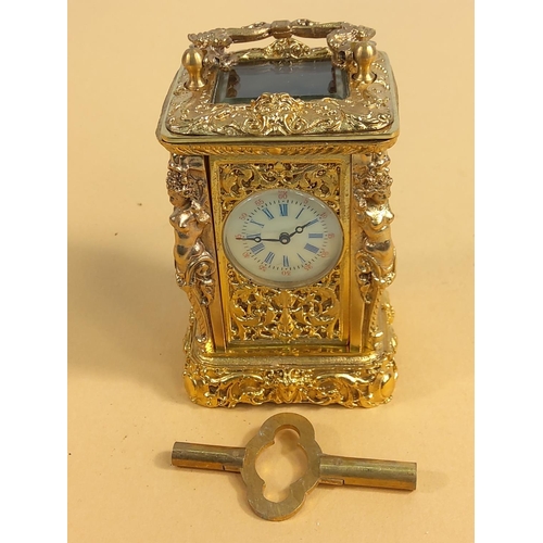 236 - Ornate gilded brass miniature carriage clock, 9cms in height