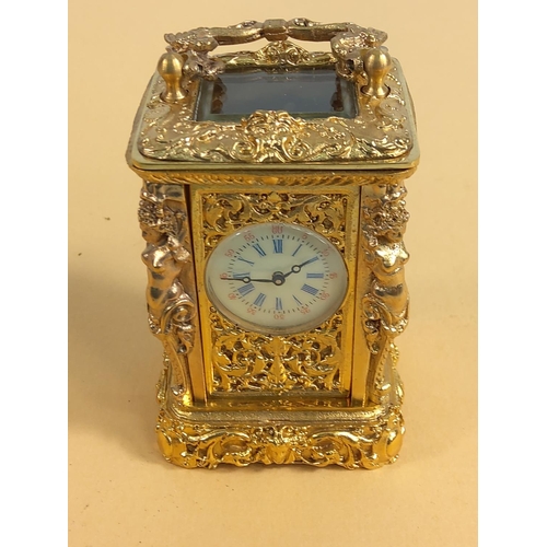 236 - Ornate gilded brass miniature carriage clock, 9cms in height