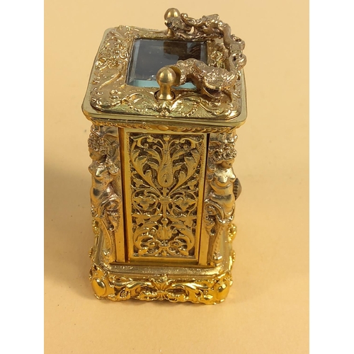 236 - Ornate gilded brass miniature carriage clock, 9cms in height