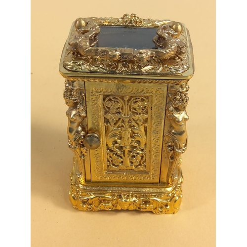 236 - Ornate gilded brass miniature carriage clock, 9cms in height