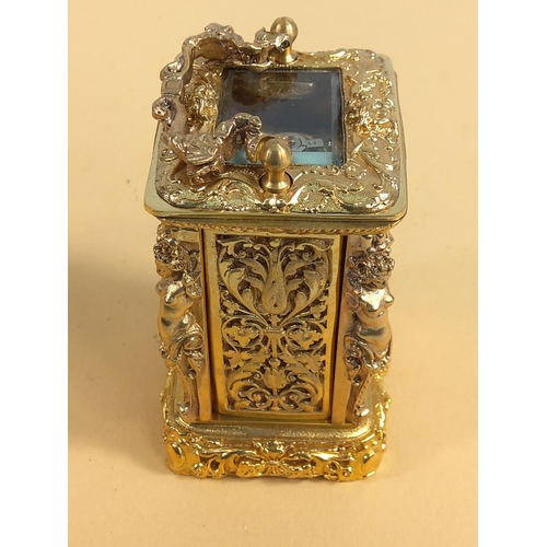 236 - Ornate gilded brass miniature carriage clock, 9cms in height