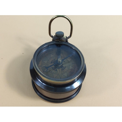 241 - Brass compass with built in tape measure, 6cms in diameter