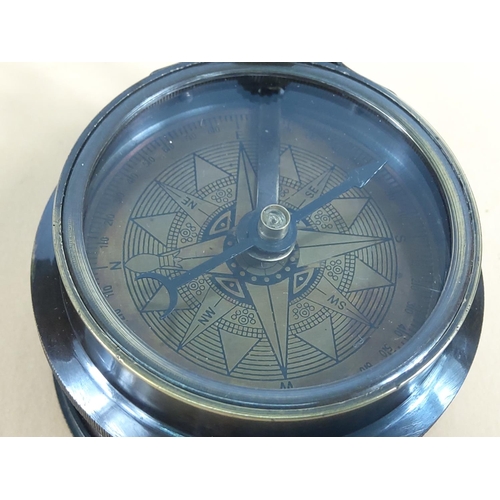 241 - Brass compass with built in tape measure, 6cms in diameter