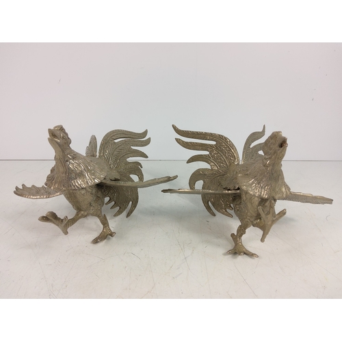 15 - Pair of cast metal fighting cockerels, 11cms in height and 19.5cms in width