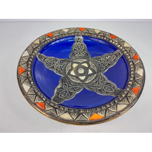 17 - Moroccan pottery plate with metal overlay, 36cms in diameter