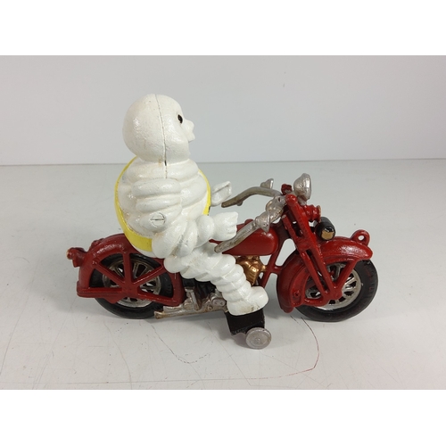 16 - Cast metal Michelin man on motorbike