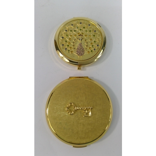 313 - An unused 1970's 21st Birthday compact and a compact with peacock design