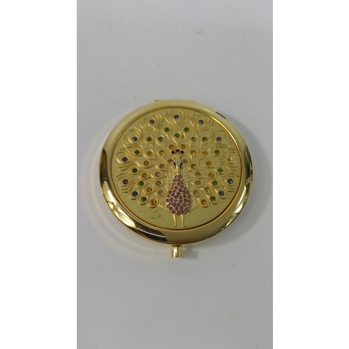 313 - An unused 1970's 21st Birthday compact and a compact with peacock design