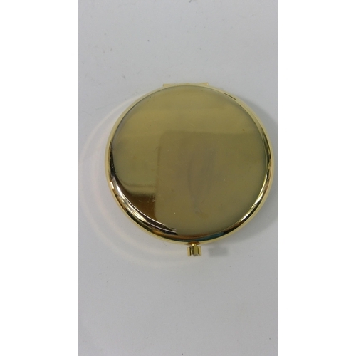 313 - An unused 1970's 21st Birthday compact and a compact with peacock design