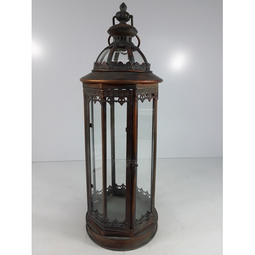 339 - Metal and glass lantern, 68cms in height