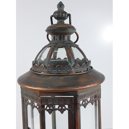 339 - Metal and glass lantern, 68cms in height