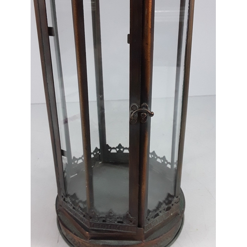 339 - Metal and glass lantern, 68cms in height