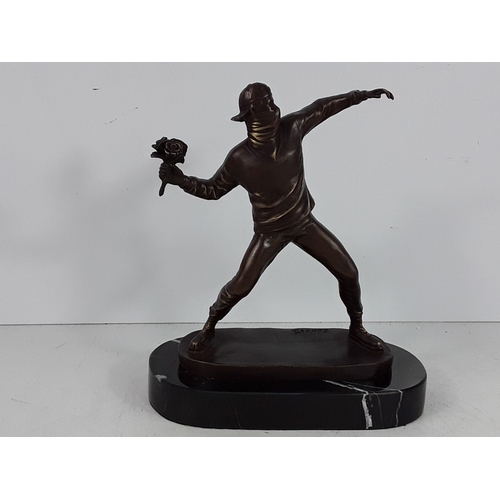 349 - Banksy style bronze on marble base - man with flowers, 25 x 22 x 12cms