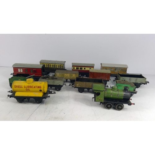 319 - Vintage metal train and various carriages and rolling stock