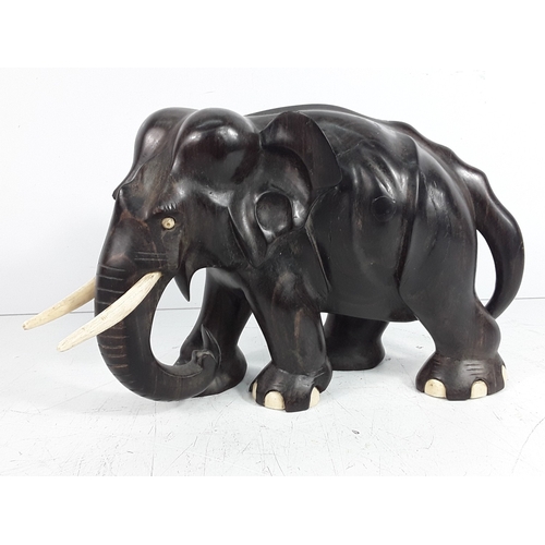 136 - Carved hardwood figure of an elephant, 15cms in height