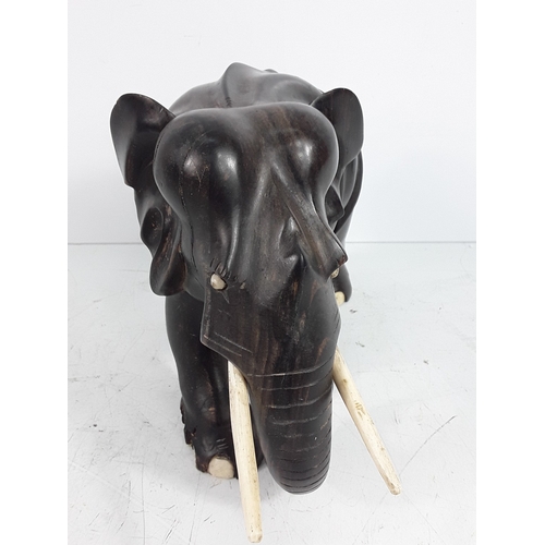 136 - Carved hardwood figure of an elephant, 15cms in height